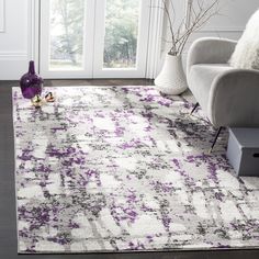 a white and purple rug in a living room