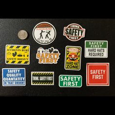 various safety first stickers on a black surface