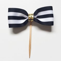 a toothpick with a black and white striped bow on it