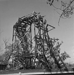 an old wooden structure sitting on top of a roof