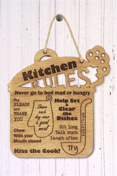 a wooden sign that says kitchen rules on it