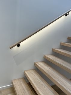 the light is on above the wooden stairs