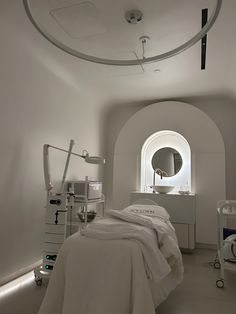 a hospital room with an arched window and medical equipment