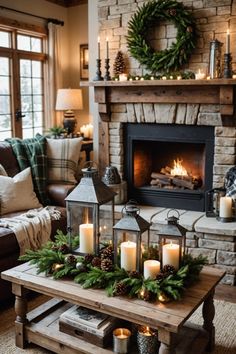 a living room decorated for christmas with candles and wreaths on the table in front of the fireplace