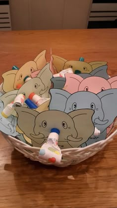 a bowl filled with toothbrushes on top of a wooden table