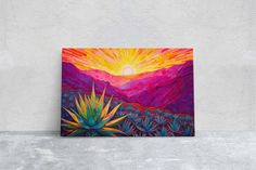 a painting on a wall with a cactus and mountains in the background