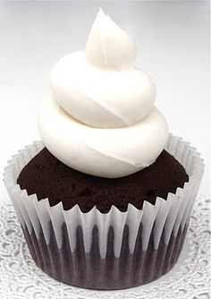 a chocolate cupcake with white frosting on top