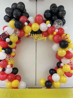 a birthday balloon wreath is displayed in front of a door