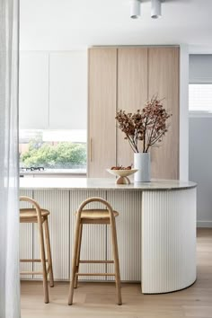 two stools are in front of the counter