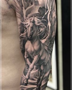 a man's arm with an angel and horse tattoo on the left side of his body