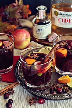 two glasses filled with mulled apple cider