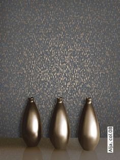 three brown vases sitting next to each other on top of a table with different colors