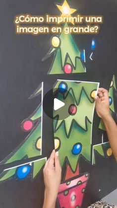 someone is cutting out a christmas tree on a blackboard with colorful lights and confetti