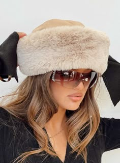 Faux fur hat   100% polyester  Fully lined, non-stretch Stylish Winter Hats For Women, Women’s Winter Hats, White Fur Hat Outfit, Material Board Fashion, Winter Outfits With Hats, Russian Hat Aesthetic, Fluffy Russian Hat, Swiss Outfit, Trendy Winter Faux Fur Hat