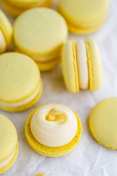 several yellow and white macaroons are on the table