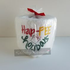 a white cake wrapped in plastic with the words happy free holidays on it's side