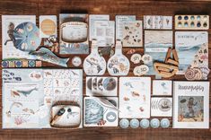 an assortment of cards and magnets on a wooden table