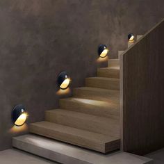 three lights on the side of a set of stairs