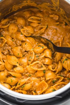 a large pot filled with pasta and meat