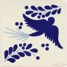 a blue and white tile with an image of a bird