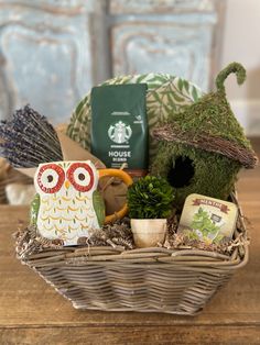 an owl figurine sitting on top of a wicker basket filled with items