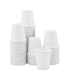 a stack of white cups sitting next to each other on top of a white table