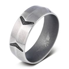 a wedding ring with an arrow in the center and black diamonds on it's side