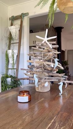 a small wooden christmas tree sitting on top of a table