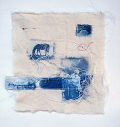 a piece of fabric with blue and white images on it, including a horse in the background