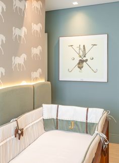 a baby's crib in the corner of a room with a horse wallpaper