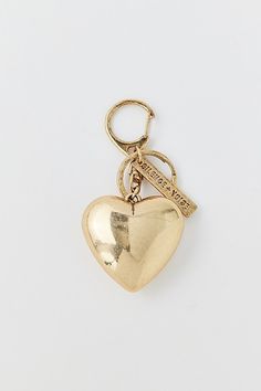 a gold heart shaped keychain on a white background