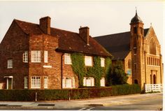 an old brick building with ivy growing on it