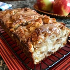 two pieces of cake sitting on top of a cooling rack next to an apple pie