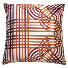 an orange and brown pillow with circles on it's side, in front of a white background