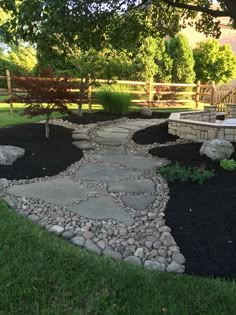 a stone path in the middle of a yard