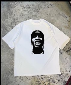 a white t - shirt with an image of a man's face on it