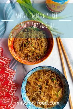 two bowls filled with noodles next to chopsticks