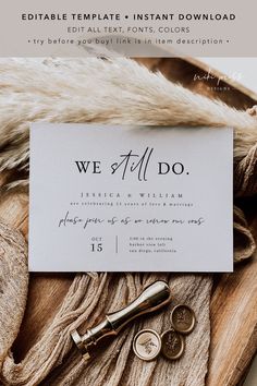 the wedding stationery is laid out on top of a pile of fur and gold buttons