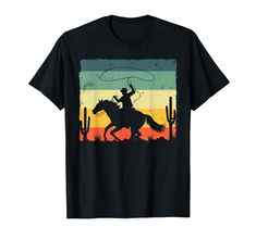 PRICES MAY VARY. This vintage western cowboy artwork is for you, him or her who loves western art and culture and horse riding. Funny for professional cattleman and herdsman dad, grandpa, uncle, husband or brother. Cute to pair with cowboy boots and howdy hat! Best birthday, Christmas or Father's Day present for a herder papa and daddy from cowboy enthusiast women, mom, wife, mother or grandma. Cool style for cowboy lover teen, youth, girl, kid or toddler. Ideal to use in a western show with fam Cowboy Print, Cowboy Design, Crewneck Style, Retro Western, Horse Rider, Key Details, Men Boys, Casual Tee, Western Cowboy