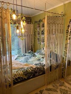 a bed room with a neatly made bed and hanging curtains