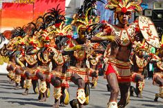 a group of people that are walking in the street with some kind of costume on