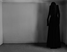 a woman standing in an empty room with her back to the camera