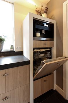 an open dishwasher door in a kitchen