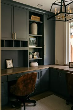 an office with gray cabinets and wooden desk