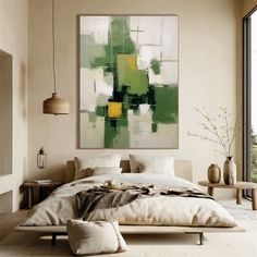 a large painting hanging above a bed in a room with white walls and flooring