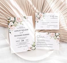 the wedding stationery is laid out on a plate with fan fans in the background