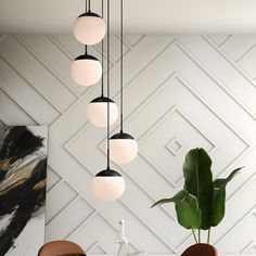 a modern dining room with white walls and gold accents