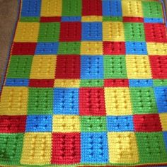 a crocheted blanket made to look like lego blocks