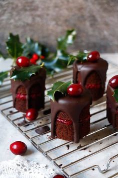 small chocolate cakes with cherries on a cooling rack