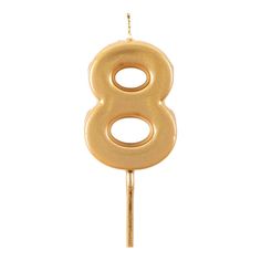 a gold number 8 candle on a stick with the number eight hanging from it's end